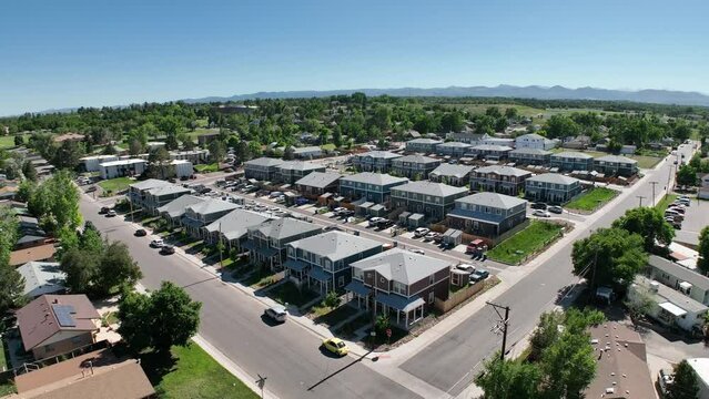 Newly built development of multi-unit townhomes for affordable housing in neighborhood south of Denver, CO - Aerial 4K drone video push-in