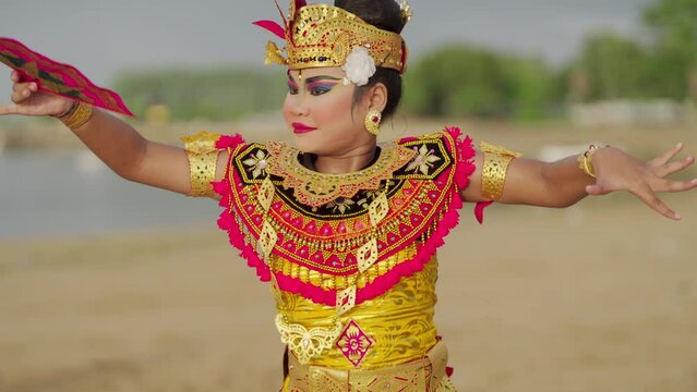 Slow motion, local balinese dancer with fan accessory, tourism and travel, bali