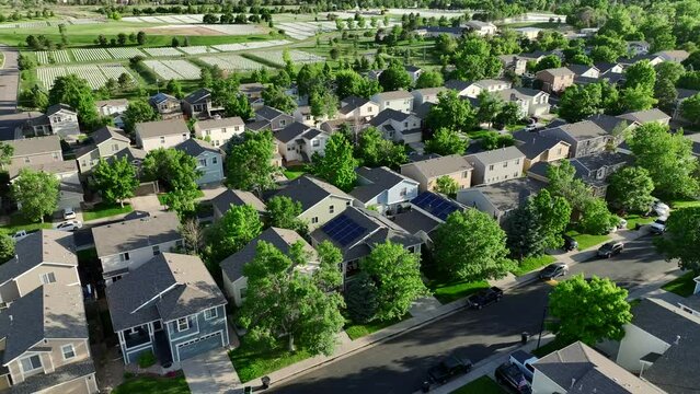 Newly completed middle class residential development with lush green trees on summer day in suburban Denver area. Drone footage filmed Lakewood, CO.