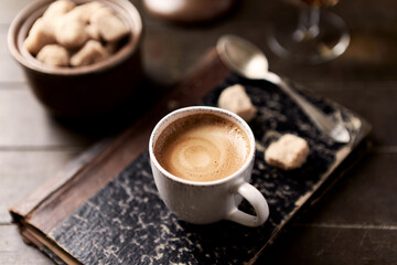 Cup of coffee on wooden background. Close up.