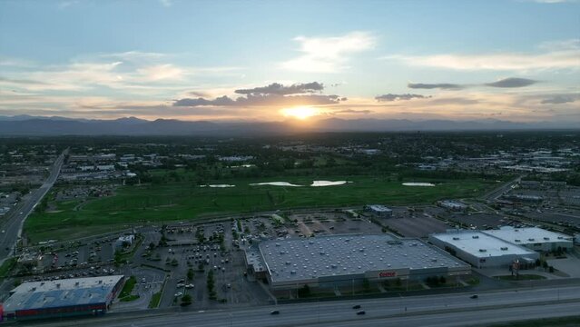 Drone footage of highway, golf course and retail stores in Englewood/Sheridan, Colorado. Aerial view panning left to right.