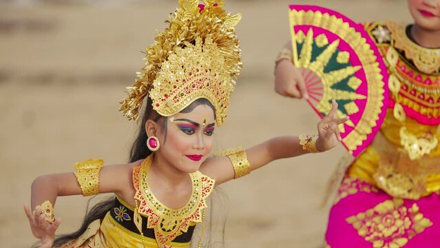 Slow motion shot of balinese dancers in vibrant costumes and makeup, bali