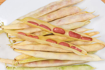 Open pods of young kidney beans on same whole pods
