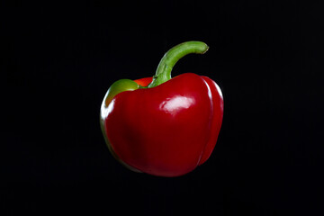 A red sweet pepper isolated on black background.