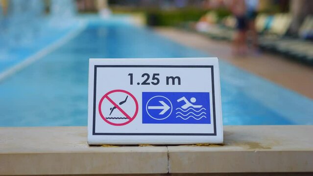 Safety sign with pool depth indication in 4k slow motion 120fps
