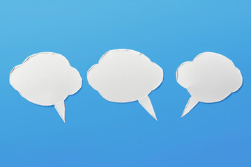 Three white speech bubbles on blue background