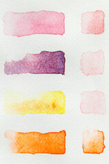 Watercolor paint swatches lined up in a grid on a white background, flatlay vertical view