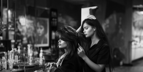 a hairdresser styling a client's hair in a salon, using scissors and styling tools to create a fashionable and flattering look