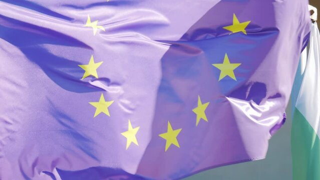 European Union flag waving against a blue sky in 4k slow motion 120fps