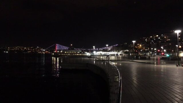 Walking along the Bosporus at night towards July 15 Martyrs Bridge