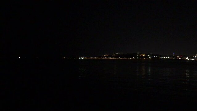 Walking along the Bosporus at night towards July 15 Martyrs Bridge