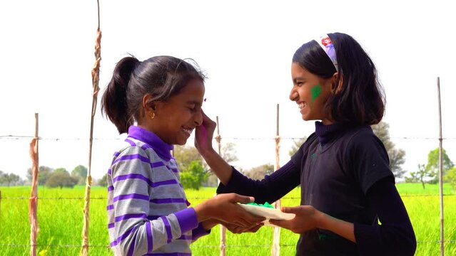 Indian Kids playing or celebrating Holi during Holi Color festival