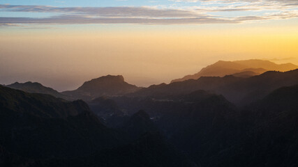 Beautiful sunset or sunrise in Madeira mountains with beautiful lights on peak Pico do Areeiro or...