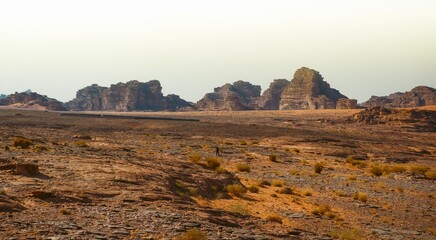 Man walking in a desert in Tabuk, Saudi Arabia