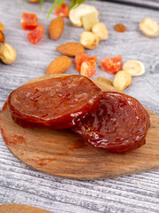 delicious nuts and dried fruits closeup on wooden background