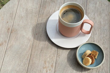 Coffee and cookies on a wooden table in the garden