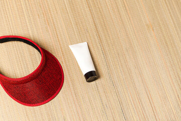 Beach mat with sunscreen and visor. Summer vacation concept. Skin care concept.