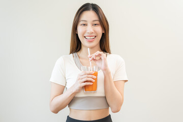 Orange detox juice, smile asian young woman hand holding a glass of vegetable juice, carrot...