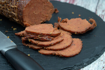 Vegan netted ham mock meat loaf on slate board