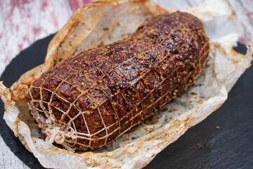 Vegan netted ham mock meat loaf on slate board