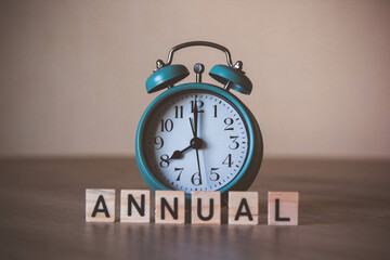 word annual in front of an alarm clock. Annual writes on wooden cubes. Time management concept. Annual event. Annual. Annual meeting. Annual schedule. 