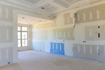 Plastering priming drywall for paint in newly constructed house - obrazy, fototapety, plakaty