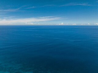 Beautiful deep blue sea and sky with clouds, seascape. Mindanao, Philippines.