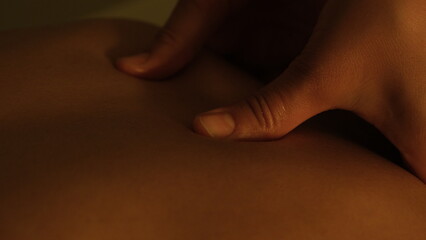 Masseuse doing back massage