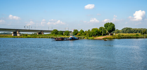 Ferry and railbridge over the river Lek (Rhine) near Culemborg, Netherlands
