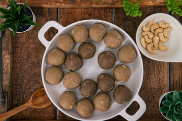 Fresh home made urad dal and millet laddu isolated and decorated. Locally called Urad Dal Ladoo, Ulundu urundan, Ulundu laddu, Kambu laddu. Selective focused millet ladoo.