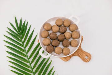 Fresh home made urad dal and millet laddu isolated and decorated. Locally called Urad Dal Ladoo, Ulundu urundan, Ulundu laddu, Kambu laddu. Selective focused millet ladoo.