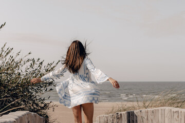 happy woman walking to the beach