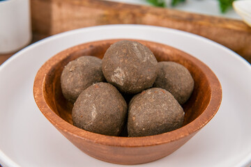 Fototapeta premium Fresh home made urad dal and millet laddu isolated and decorated. Locally called Urad Dal Ladoo, Ulundu urundan, Ulundu laddu, Kambu laddu. Selective focused millet ladoo.