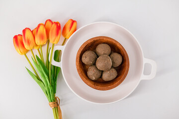 Fresh home made urad dal and millet laddu isolated and decorated. Locally called Urad Dal Ladoo, Ulundu urundan, Ulundu laddu, Kambu laddu. Selective focused millet ladoo.