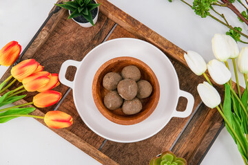 Fresh home made urad dal and millet laddu isolated and decorated. Locally called Urad Dal Ladoo, Ulundu urundan, Ulundu laddu, Kambu laddu. Selective focused millet ladoo. ...