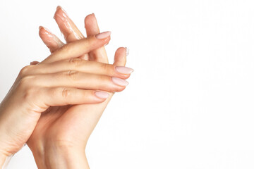 Female hands wipe running gel over the skin on a light background