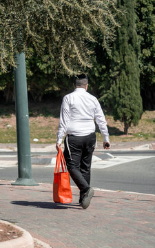 Religious young jew walks down the street. Back view. Netania, Israel, 13 april 2022 (172)