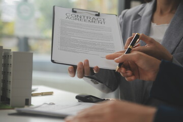 Business Signing a Contract Buy - sell house, insurance agent analyzing about home investment loan Real Estate concept.