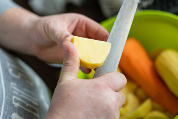 Man peeling vegetables with a knife