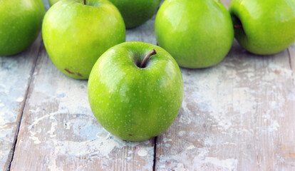 organic granny smith apples on wooden table