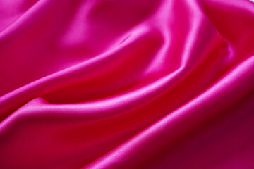 Pink silk or satin background, wavy, elegant and elegant. Close-up, background. Space for designblur or blurry