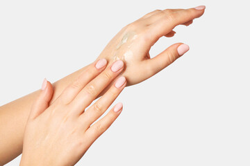 Women's hands in flowing gel, spreading over their hands. On a light background