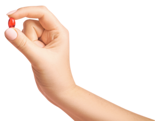 Female hand holding red pill on empty background