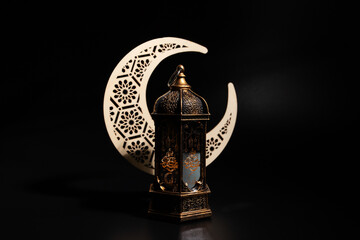 Ramadan Mubarak, moon and lantern on black background, Eastern culture, traditional decoration