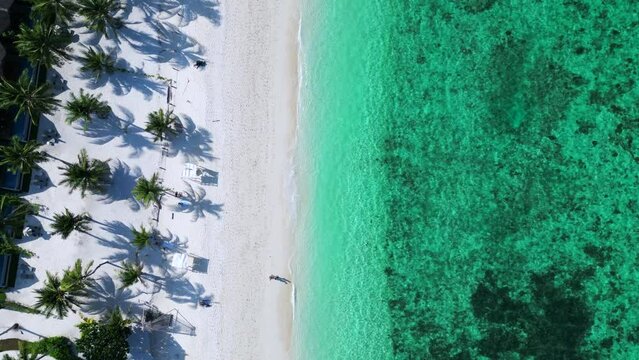 palms shadow blue sea thai beach rocky island Dramatic aerial view flight drone