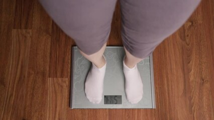 Female feet step on scales, weight measurement, health monitoring, body mass index, overweight, weight gain and loss, diet and obese
