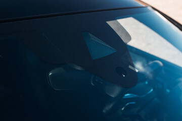 Rain and light sensor on the windshield of the car