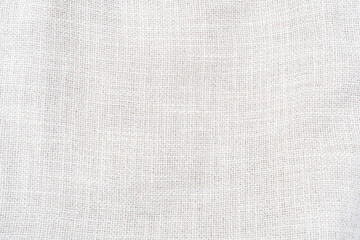 White hessian sackcloth woven jute burlap fabric cloth textile texture pattern background in white...