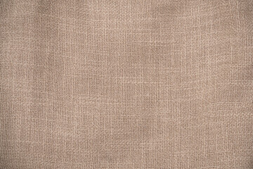 Hessian sackcloth woven jute burlap fabric cloth textile texture pattern background in brown beige...