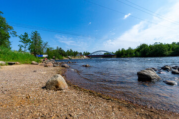 A fast river under a blue sky.